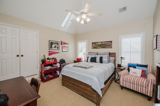 312 La Playa Pl, Homewood, AL 35209 - bedroom with light colored carpet, a closet, lofted ceiling, a skylight, and ceiling fan