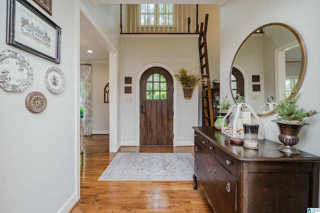 312 La Playa Pl, Homewood, AL 35209 - foyer entrance featuring wood finished floors, arched walkways, baseboards, and a towering ceiling