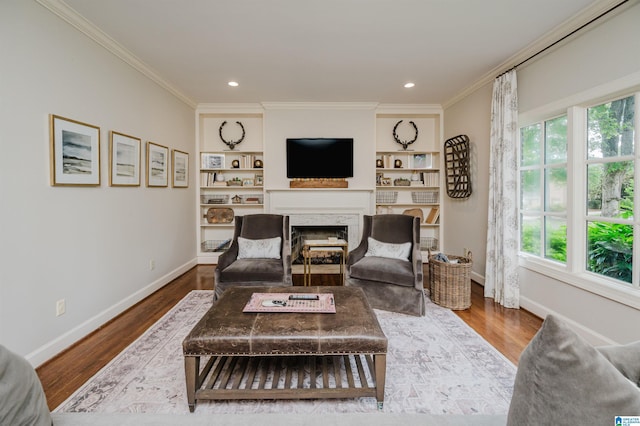 312 La Playa Pl, Homewood, AL 35209 - living area featuring a fireplace, baseboards, plenty of natural light, wood finished floors, and crown molding