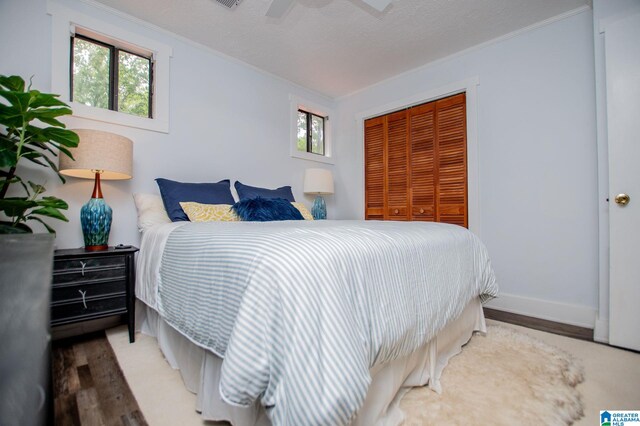 327 County Road 4315, Wedowee, AL 36278 - bedroom with ornamental molding, a closet, wood finished floors, and multiple windows
