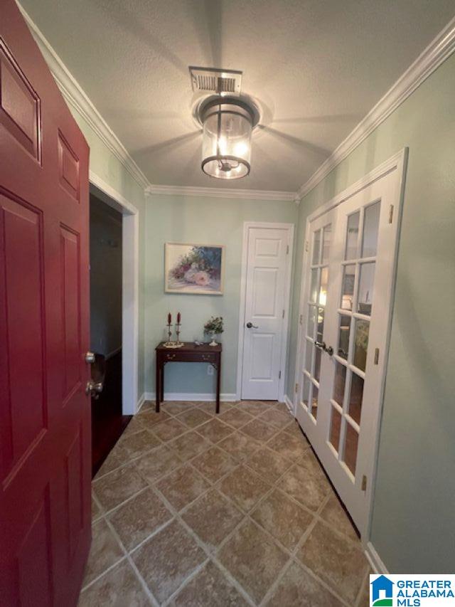 104 Brent Way, Alabaster, AL 35007 - foyer with french doors, crown molding, dark tile patterned floors, baseboards, and a textured ceiling