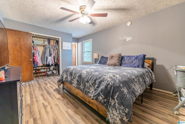 1214 Wildoak Dr, Anniston, AL 36206 - bedroom with a textured ceiling, light wood-type flooring, a closet, and ceiling fan