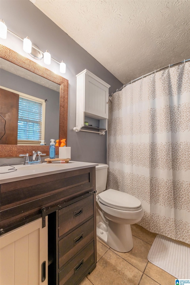 1214 Wildoak Dr, Anniston, AL 36206 - bathroom with vanity, tile patterned flooring, toilet, a textured ceiling, and curtained shower
