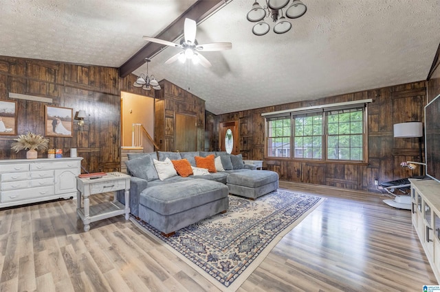 1214 Wildoak Dr, Anniston, AL 36206 - living room featuring wooden walls, a textured ceiling, a ceiling fan, wood finished floors, and stairs