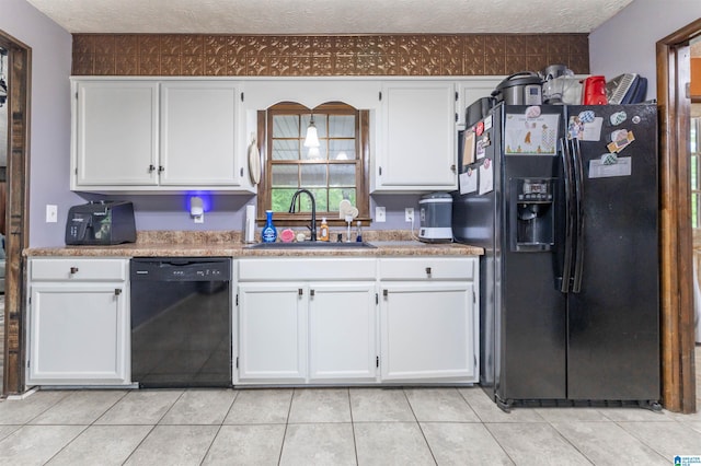 1214 Wildoak Dr, Anniston, AL 36206 - kitchen featuring black appliances, a sink, white cabinets, light countertops, and a textured ceiling