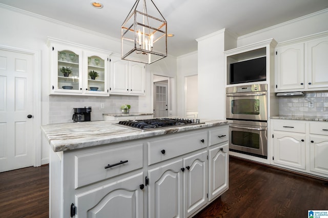 2563 Aspen Cove Dr, Vestavia Hills, AL 35243 - kitchen with stainless steel appliances, a chandelier, decorative backsplash, dark wood finished floors, and crown molding