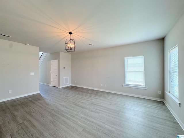 115 Ridgeview Cir, Jemison, AL 35085 - unfurnished living room featuring wood finished floors, a chandelier, and baseboards