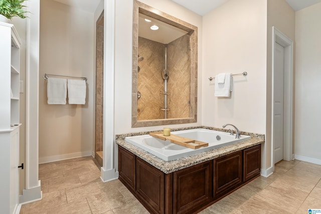 2982 Kelham Grove Way, Birmingham, AL 35242 - bathroom with a garden tub, baseboards, and a tile shower