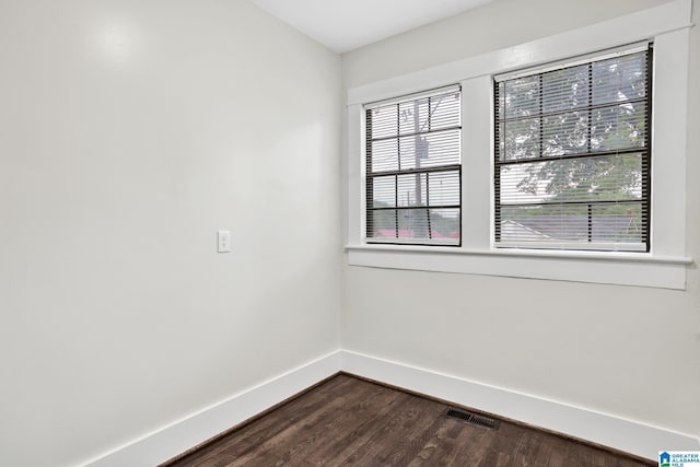 809 15th St W, Birmingham, AL 35208 - empty room with baseboards, dark wood finished floors, and healthy amount of natural light