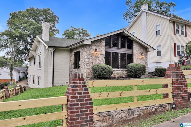 809 15th St W, Birmingham, AL 35208 - view of front of house with a chimney, stone siding, and a fenced front yard