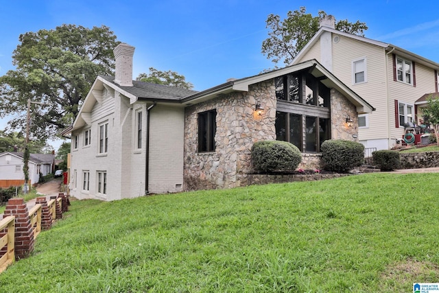 809 15th St W, Birmingham, AL 35208 - view of front of home with a chimney, stone siding, and a front lawn