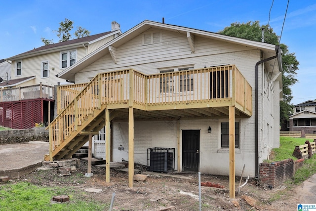 809 15th St W, Birmingham, AL 35208 - back of property featuring brick siding, a deck, and stairway