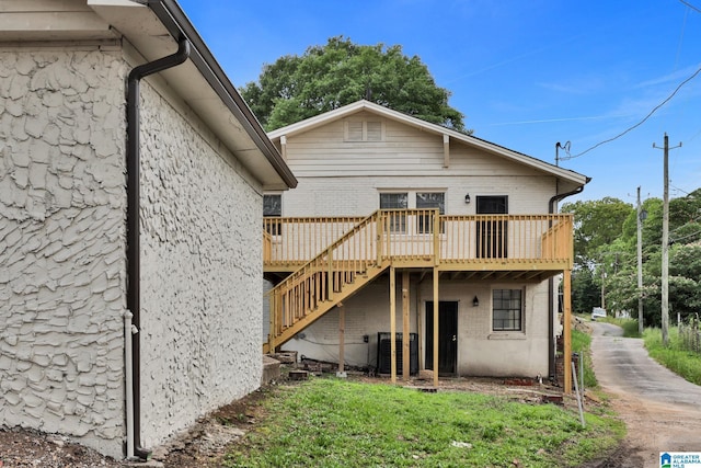 809 15th St W, Birmingham, AL 35208 - back of house with a wooden deck, stairway, central AC, and brick siding