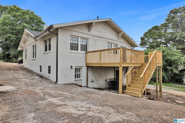 809 15th St W, Birmingham, AL 35208 - back of property with brick siding, a deck, stairs, and central AC unit
