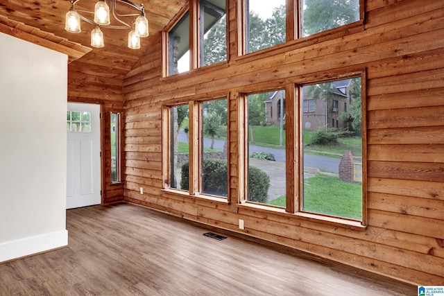 809 15th St W, Birmingham, AL 35208 - unfurnished room with baseboards, wood ceiling, high vaulted ceiling, wood finished floors, and a chandelier