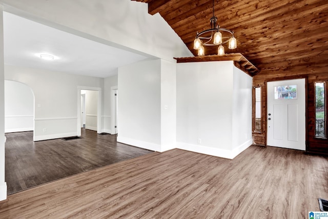 809 15th St W, Birmingham, AL 35208 - entryway with a chandelier, wood finished floors, baseboards, wooden ceiling with exposed beams, and arched walkways