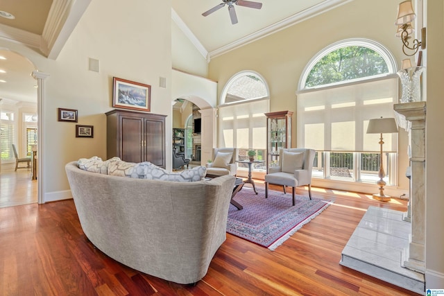 1272 Highland Lakes Trl, Birmingham, AL 35242 - living room featuring arched walkways, ornate columns, ceiling fan, ornamental molding, and wood finished floors