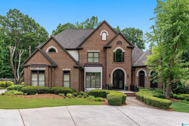 1272 Highland Lakes Trl, Birmingham, AL 35242 - view of front of home with brick siding, a shingled roof, and a front yard