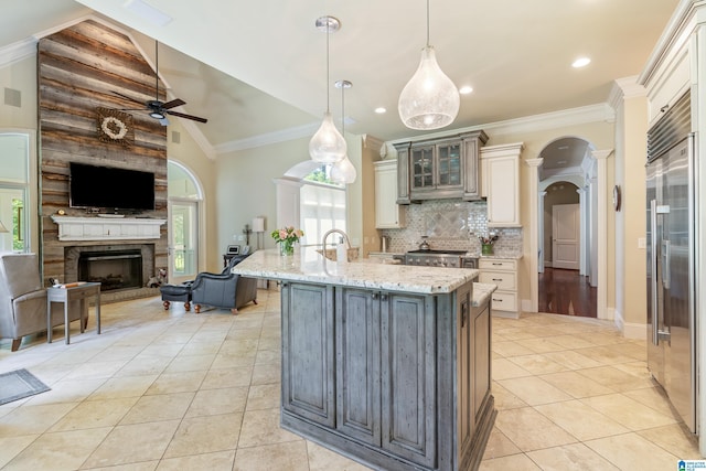 1272 Highland Lakes Trl, Birmingham, AL 35242 - kitchen with stainless steel built in fridge, a ceiling fan, open floor plan, decorative columns, and light tile patterned flooring