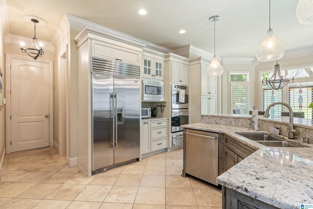 1272 Highland Lakes Trl, Birmingham, AL 35242 - kitchen featuring built in appliances, a chandelier, a sink, crown molding, and tasteful backsplash