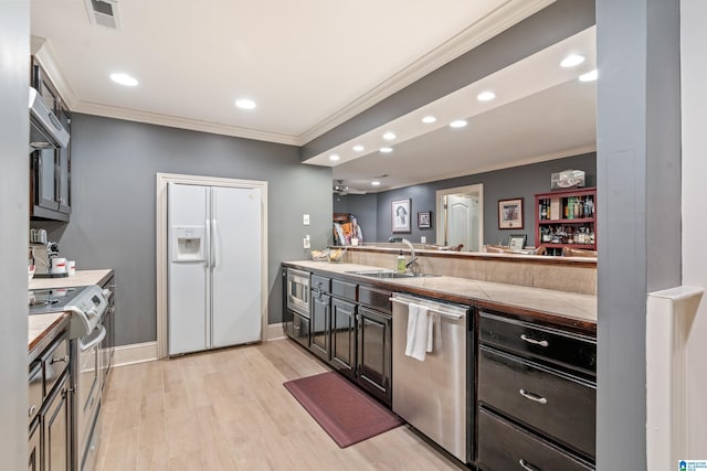 1272 Highland Lakes Trl, Birmingham, AL 35242 - kitchen featuring appliances with stainless steel finishes, a sink, crown molding, light wood-style floors, and recessed lighting