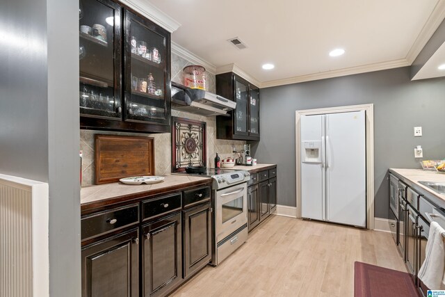 1272 Highland Lakes Trl, Birmingham, AL 35242 - kitchen featuring white refrigerator with ice dispenser, stainless steel range with electric cooktop, under cabinet range hood, tasteful backsplash, and light wood-style flooring