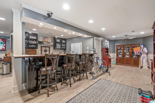 1272 Highland Lakes Trl, Birmingham, AL 35242 - indoor wet bar featuring crown molding, wood finished floors, backsplash, white fridge with ice dispenser, and a wainscoted wall