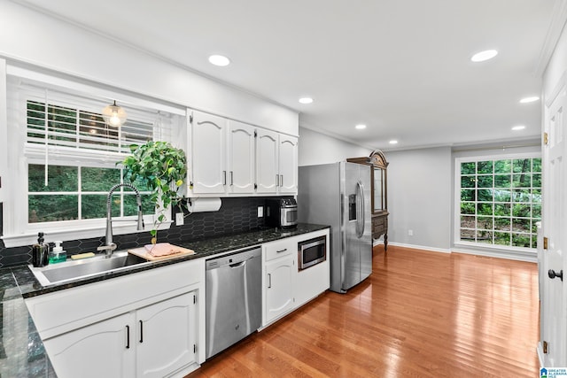 2013 Crossvine Rd, Hoover, AL 35244 - kitchen featuring appliances with stainless steel finishes, a sink, white cabinets, backsplash, and light wood-style floors