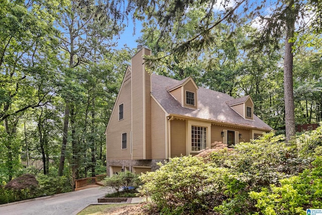 2013 Crossvine Rd, Hoover, AL 35244 - view of property exterior with a garage, driveway, a chimney, and roof with shingles