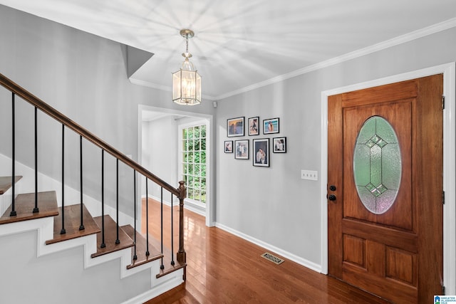 2013 Crossvine Rd, Hoover, AL 35244 - entryway featuring baseboards, dark wood-style floors, stairs, ornamental molding, and a chandelier