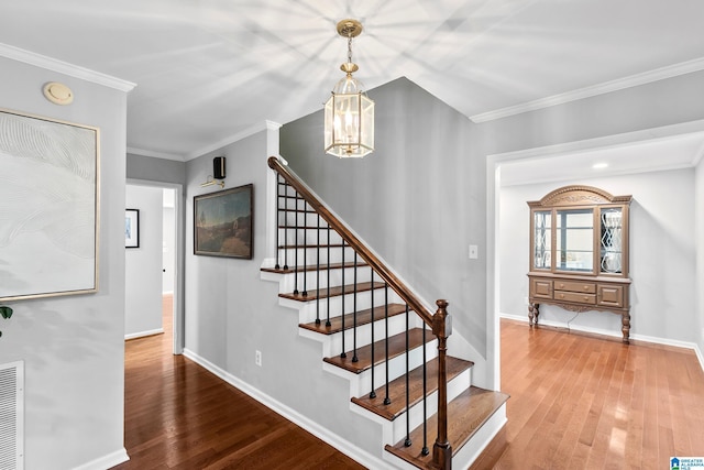 2013 Crossvine Rd, Hoover, AL 35244 - stairway with wood finished floors, baseboards, ornamental molding, and a chandelier