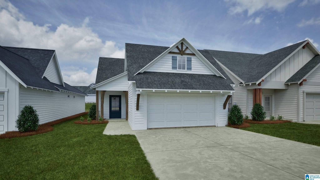 156 Shiloh Creek Dr, Calera, AL 35040 - view of front of house featuring concrete driveway, a front lawn, a garage, a shingled roof, and board and batten siding