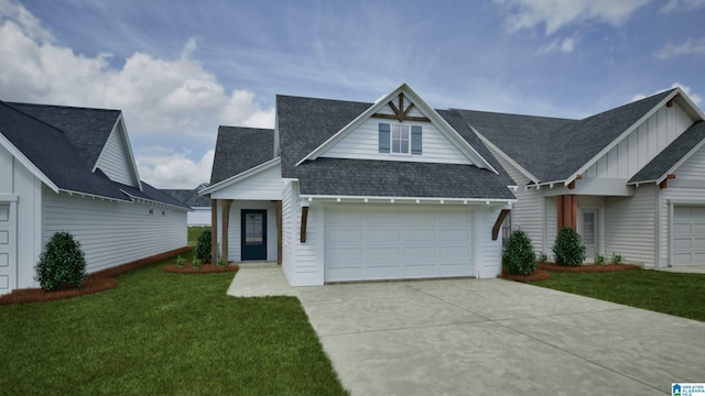 156 Shiloh Creek Dr, Calera, AL 35040 - view of front of house featuring concrete driveway, a front lawn, a garage, a shingled roof, and board and batten siding