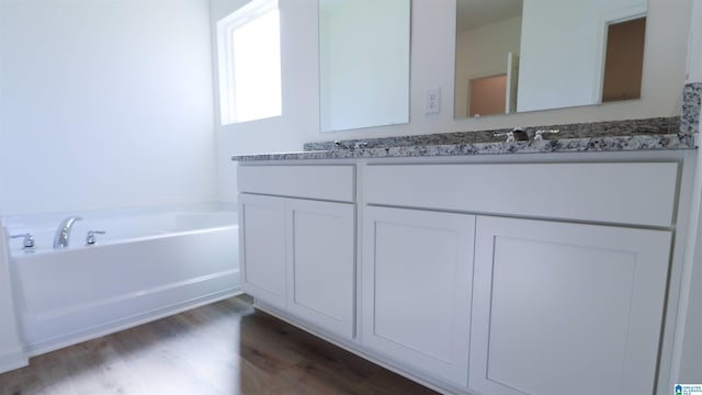 629 Fish Camp Rd, Chelsea, AL 35043 - full bath featuring double vanity, a bath, and wood finished floors