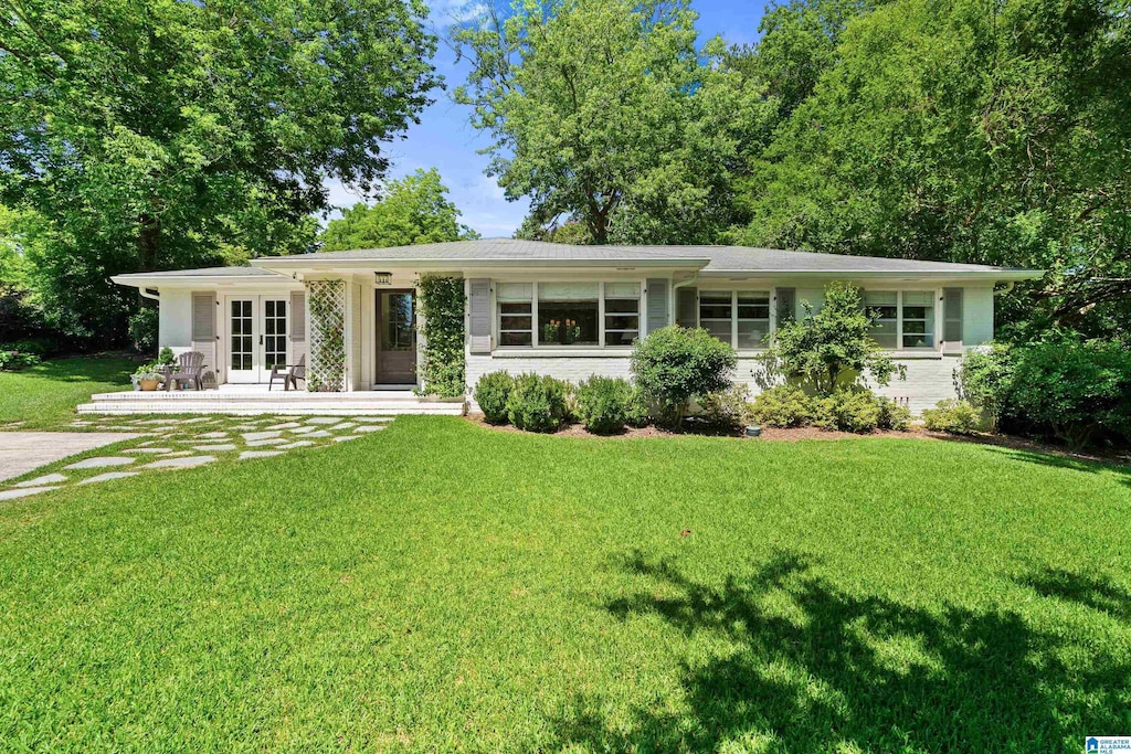 2121 Vestaview Cir, Vestavia Hills, AL 35216 - ranch-style home with french doors, a front yard, and brick siding