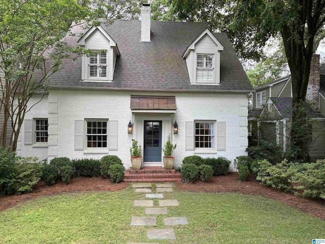 409 Euclid Ave, Mountain Brook, AL 35213 - cape cod home featuring a front lawn, a chimney, and roof with shingles