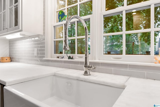 409 Euclid Ave, Mountain Brook, AL 35213 - kitchen view of decorative backsplash, a sink, and glass insert cabinets