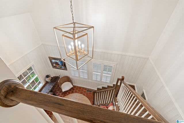 409 Euclid Ave, Mountain Brook, AL 35213 - staircase with a chandelier, wainscoting, and a decorative wall