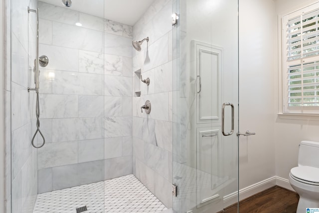 409 Euclid Ave, Mountain Brook, AL 35213 - bathroom featuring toilet, a shower stall, wood finished floors, and baseboards