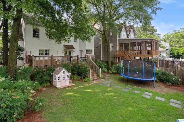 409 Euclid Ave, Mountain Brook, AL 35213 - view of yard featuring stairway, a wooden deck, a sunroom, and a trampoline