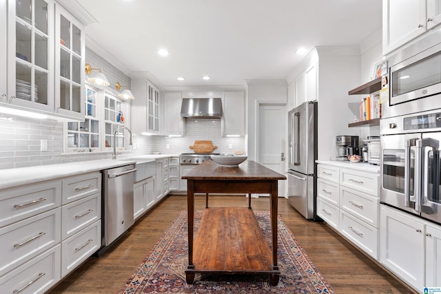 409 Euclid Ave, Mountain Brook, AL 35213 - kitchen with appliances with stainless steel finishes, wall chimney exhaust hood, a sink, decorative backsplash, and recessed lighting