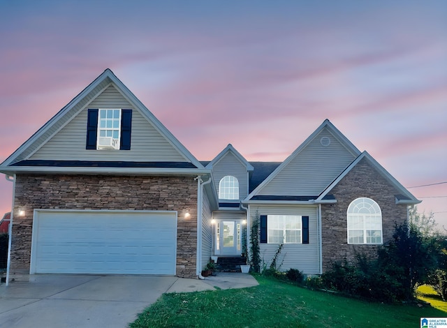184 Raptor Way, Anniston, AL 36207 - traditional home with stone siding, driveway, a garage, and a lawn