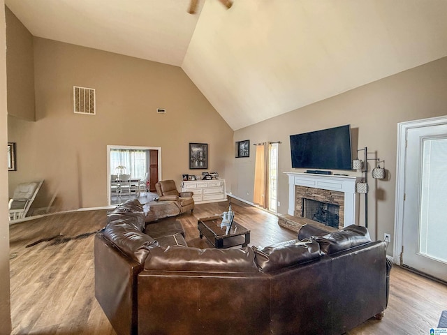 184 Raptor Way, Anniston, AL 36207 - living room featuring wood finished floors, high vaulted ceiling, a fireplace, and baseboards