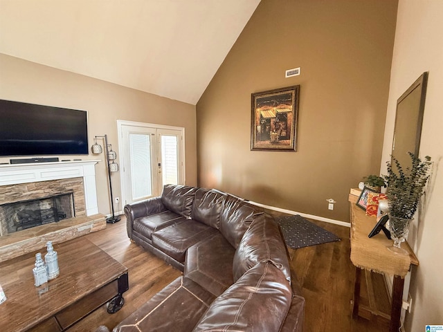 184 Raptor Way, Anniston, AL 36207 - living area featuring wood finished floors, a fireplace, high vaulted ceiling, and baseboards