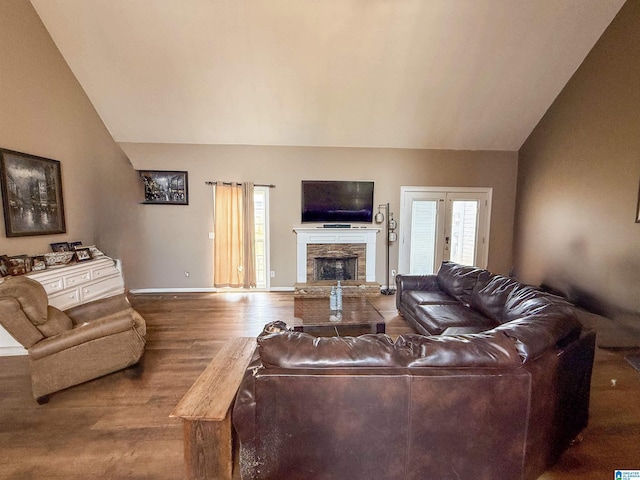 184 Raptor Way, Anniston, AL 36207 - living room featuring lofted ceiling, wood finished floors, a fireplace, and baseboards