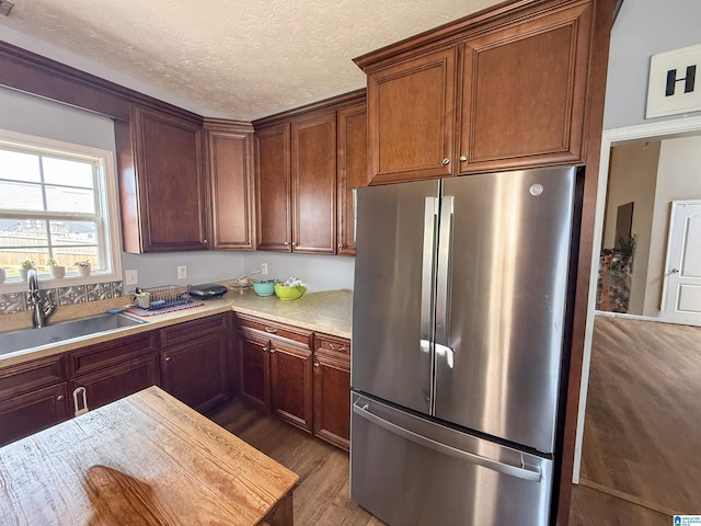 184 Raptor Way, Anniston, AL 36207 - kitchen with freestanding refrigerator, a sink, light wood-style floors, light countertops, and a textured ceiling
