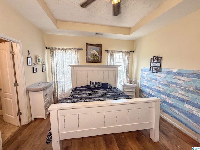 184 Raptor Way, Anniston, AL 36207 - bedroom featuring a raised ceiling, wood finished floors, baseboards, and a ceiling fan