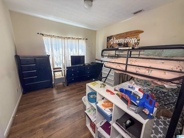 184 Raptor Way, Anniston, AL 36207 - bedroom with dark wood-style flooring, baseboards, and a textured ceiling