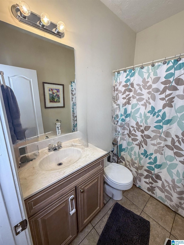 184 Raptor Way, Anniston, AL 36207 - bathroom with tile patterned floors, vanity, toilet, and curtained shower