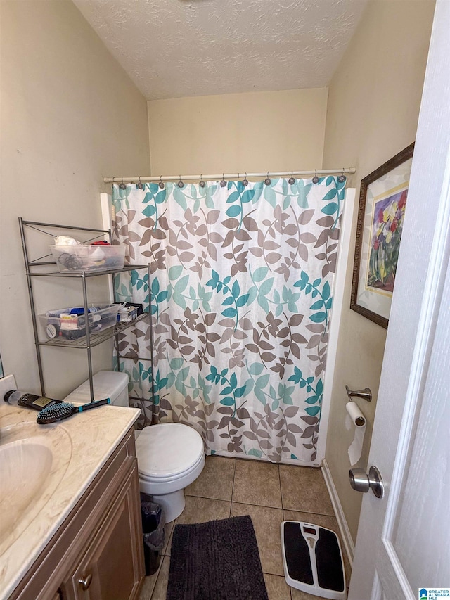 184 Raptor Way, Anniston, AL 36207 - full bath with tile patterned flooring, toilet, vanity, a textured ceiling, and a shower with curtain